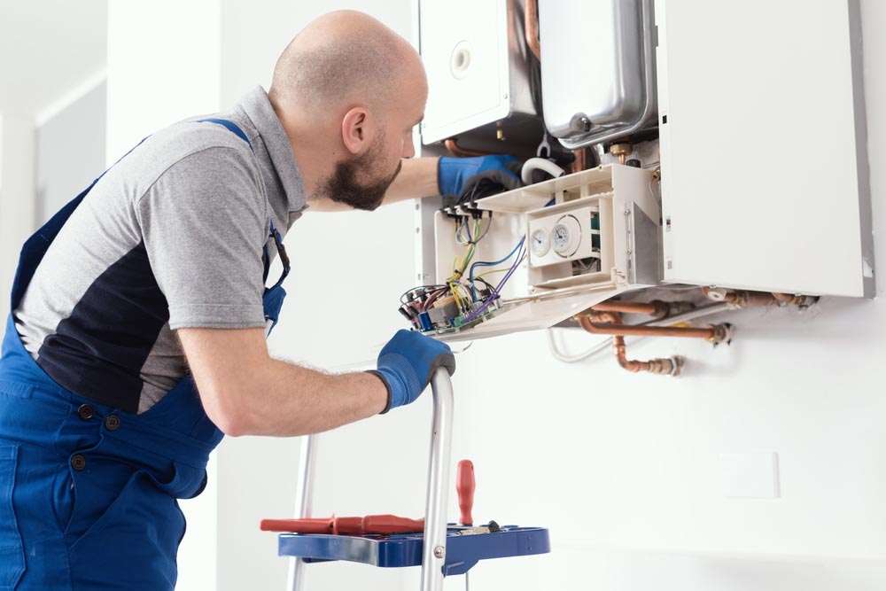 plumber checking tankless water heater Lynwood, WA